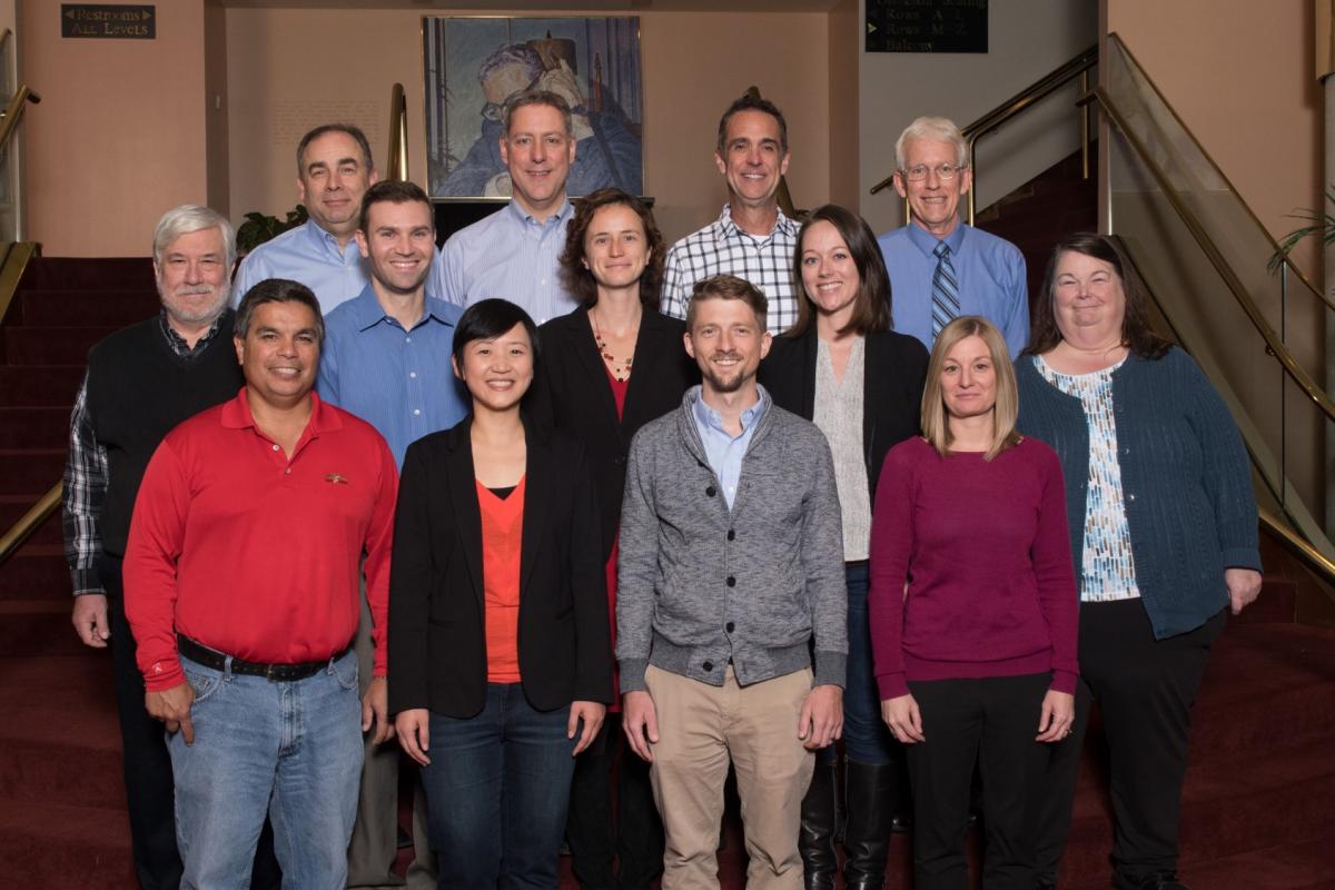 Clinical psychology faculty grouped on a staircase. Mario Scalora, David DiLillo, Cary Savage, and David Hansen are in the back row. Will Spaulding, Tim Nelson, Tierney Lorenz, Becca Brock, and Deb Hope are in the middle row. Dennis McChargue, Kathy Chiou, Trey Andrews, and Corrie Davies are standing in front.